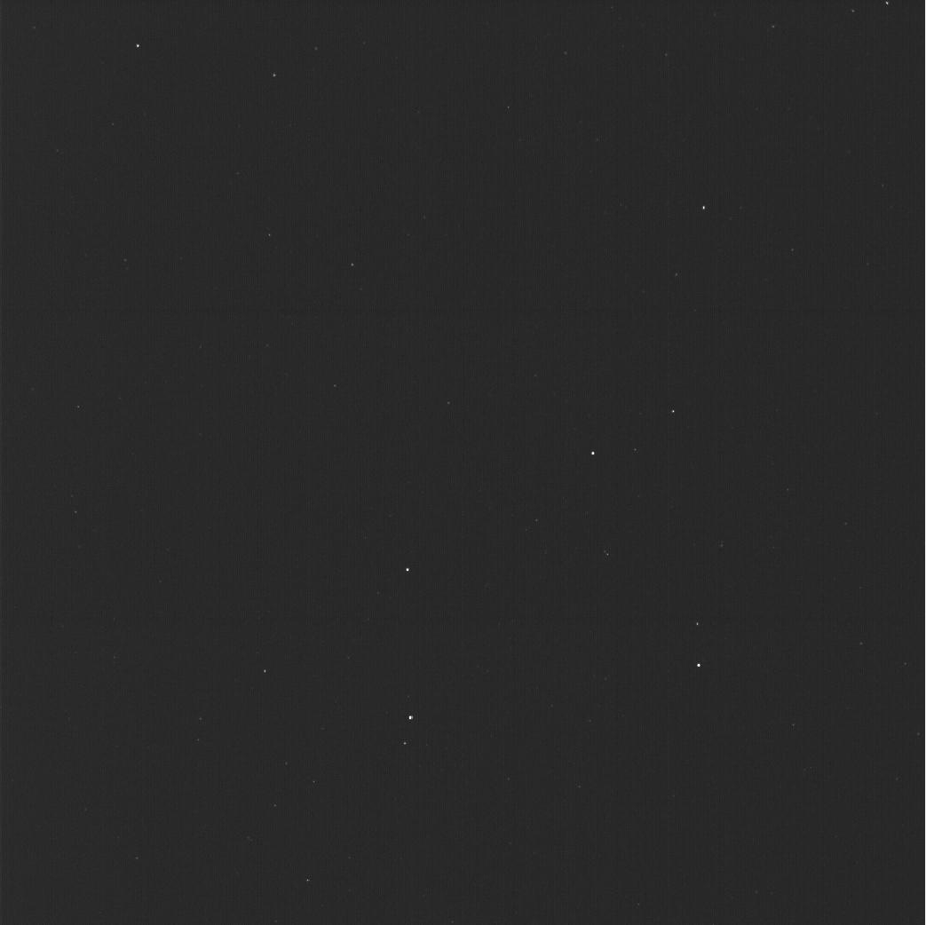 a nearly all black image, with a half dozen faint points of light scattered about