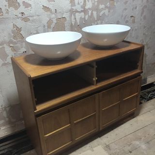 bathroom with white sink and wooden shelve