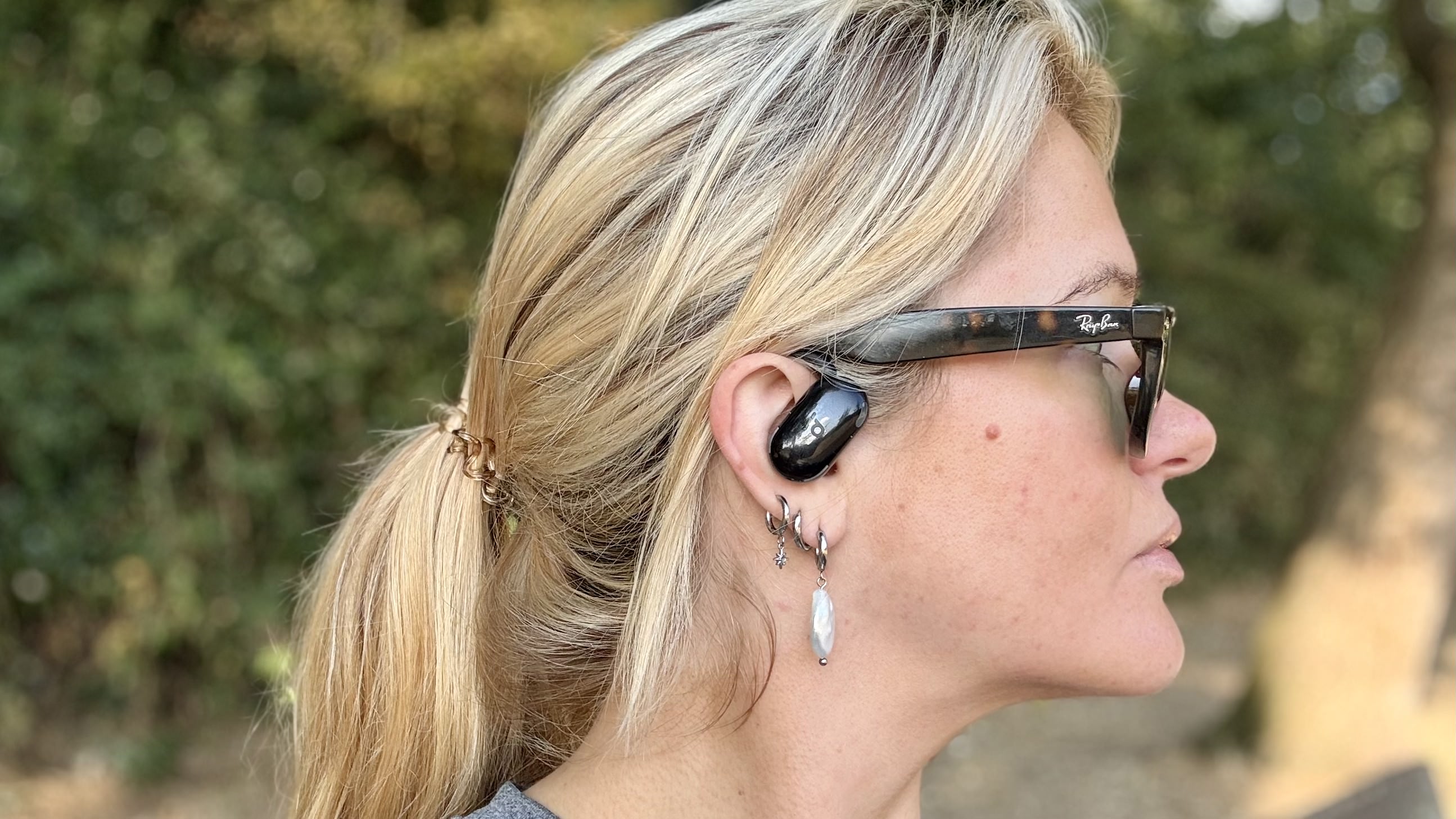 Becca Caddy wearing Soundcore Anker V20i open earbuds