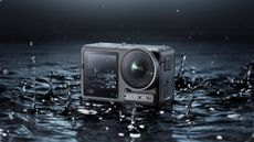 DJI Osmo Action 4 camera in shallow water surrounded by splashes