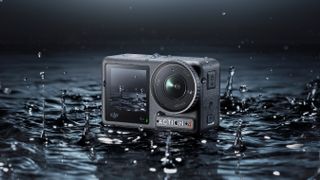 DJI Osmo Action 4 camera in shallow water surrounded by splashes