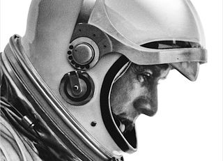 A '60s-era test pilot in a spacesuit and helmet