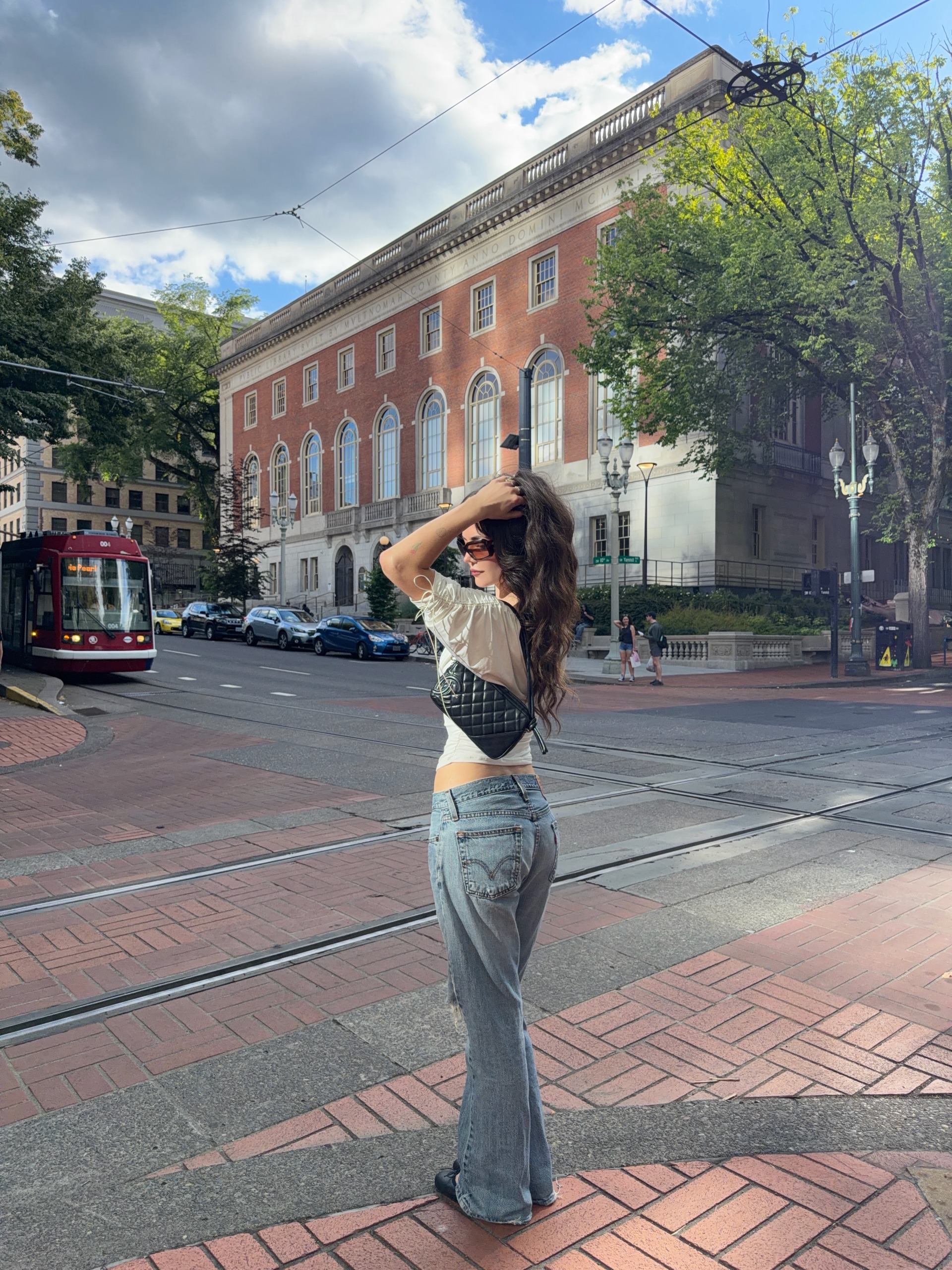A woman wearing low rise bootcut jeans in 2026.