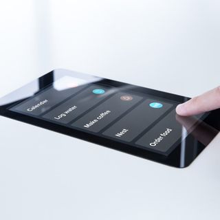 A finger is shown tapping on the 'Order Food' option on the SmartDesk 3 touchscreen