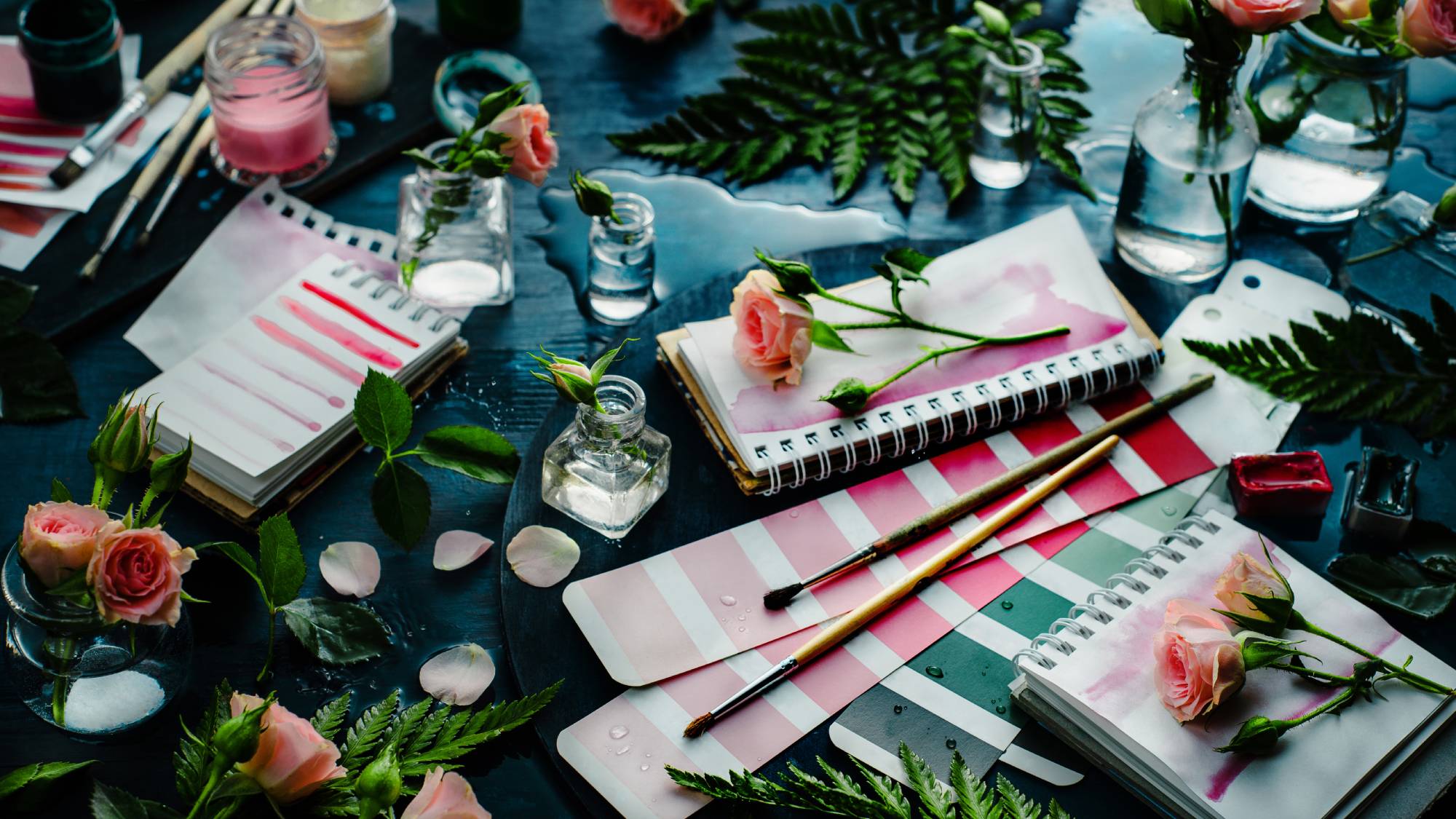 Paint brushes and color swatches with roses