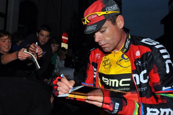 Cadel Evans busily signed autographs for the fans.
