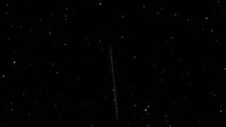 A line of white dots against a dark background