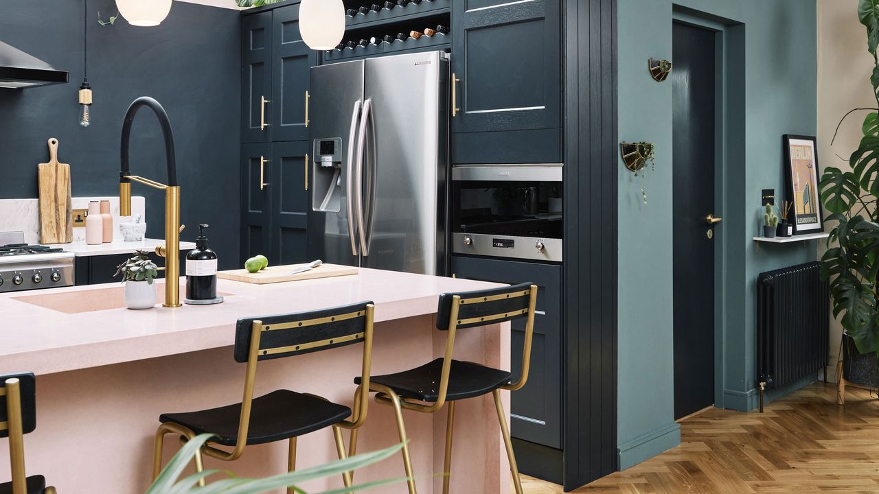 navy blue kitchen with island and large fridge