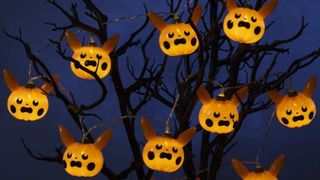 Pikachu Pumpkin String Lights on a spooky dead tree, against a dark blue background