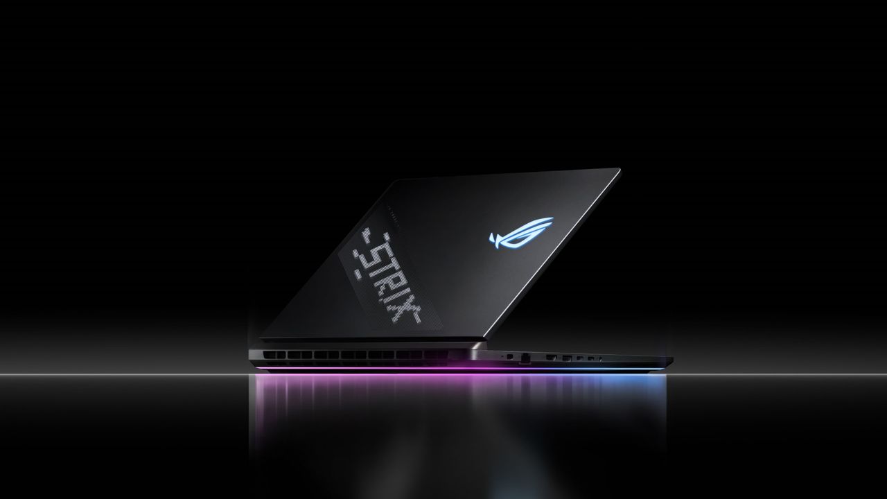 Asus ROG Strix Scar 18 in a black room with RGB lighting on