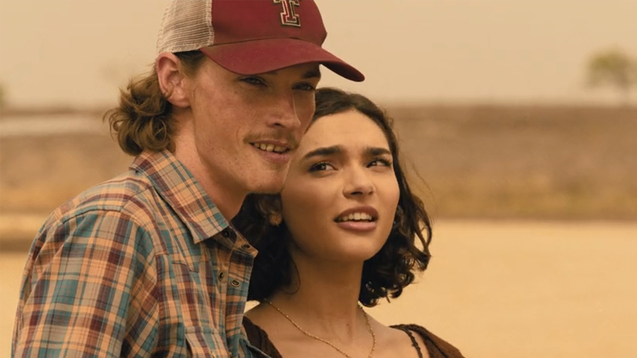 Jacob Lofland looking off into the distance and Paulina Chavez looking at him in Landman