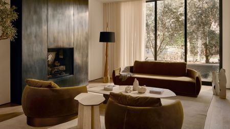 living room with green velvet sofa, accent chair and marble coffee table