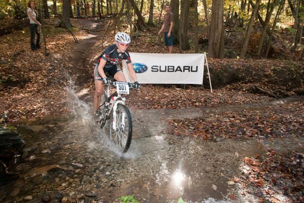 Second-place finisher Abby Strigel (Trek Stores of Madison) crosses the creek at the Wigwam MTB Challenge.