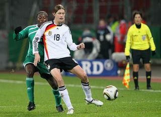 ) Helen Ukaonu of Nigeria challenges Kerstin Gasrefrekes of Germany during the women's international friendly match between Germany and Nigeria at BayArena on November 25, 2010 in Leverkusen, Germany. (Photo by Christof Koepsel/Bongarts/Getty Images)