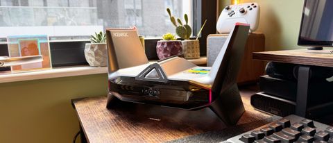 Acemagic M2A Starship mini gaming PC on a desk, showing its ports and unusual design on a wooden desk