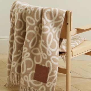 A light brown and white textured throw blanket from Net-A-Porter