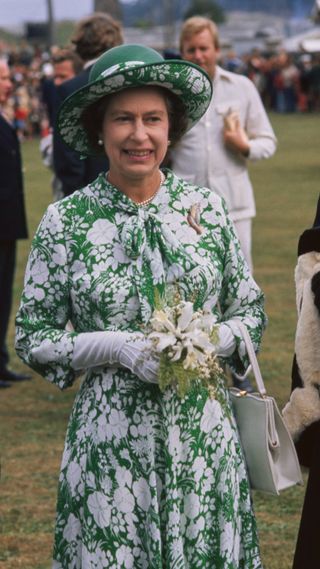 Queen Elizabeth II wearing a white and green printed outfit