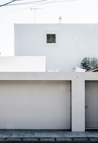 A concrete house with white cladding