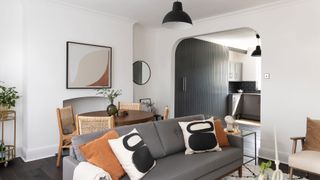 white living room with archway through to kitchen