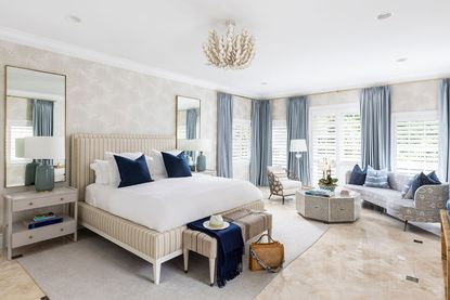 Large cream bedroom, with marble floor and sofa and seating area