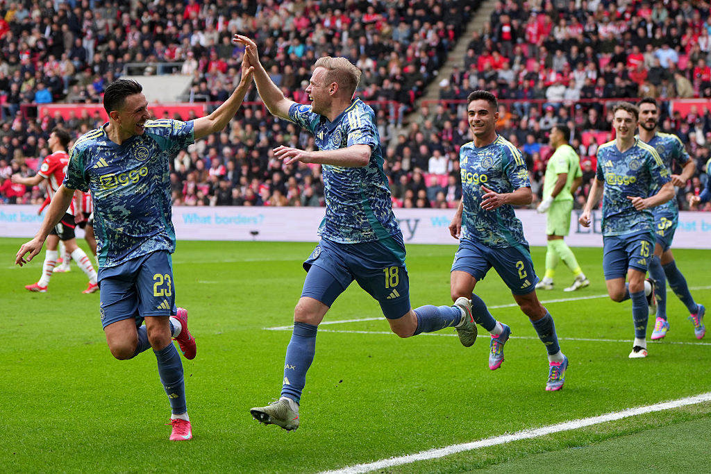 Davy Klaassen #18 of Ajax and Steven Berghuis #23 of Ajax react after Klaassen scored his team's first goal in the first half of the Eredivisie match between PSV and AFC Ajax at Philips Stadion on March 30, 2025 in Eindhoven, Netherlands