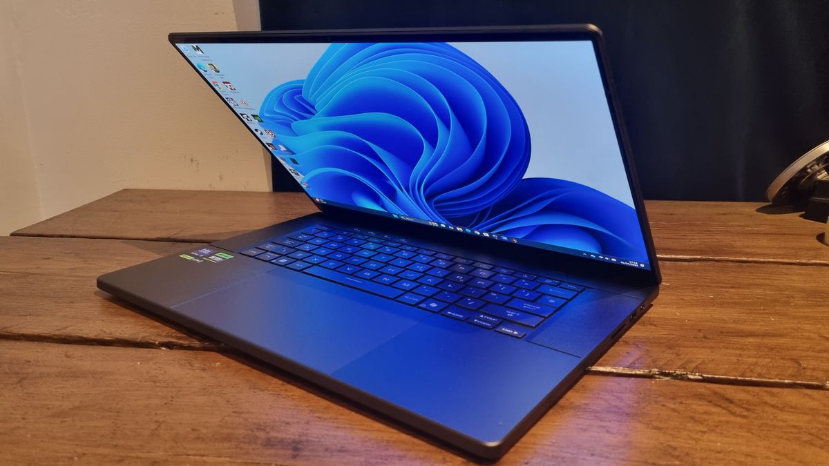 The Asus ROG Zephyrus G16 2025, half open on a wooden desk