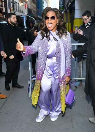 Oprah in a purple and gold ensemble