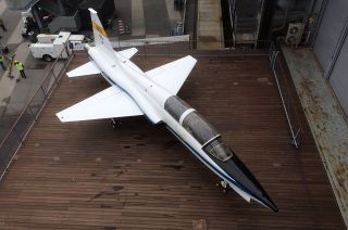 The NASA T-38 jet, tail number 913, is seen on the port side aircraft elevator as it is raised onto the flight deck of the Intrepid Sea, Air and Space Museum in New York City.