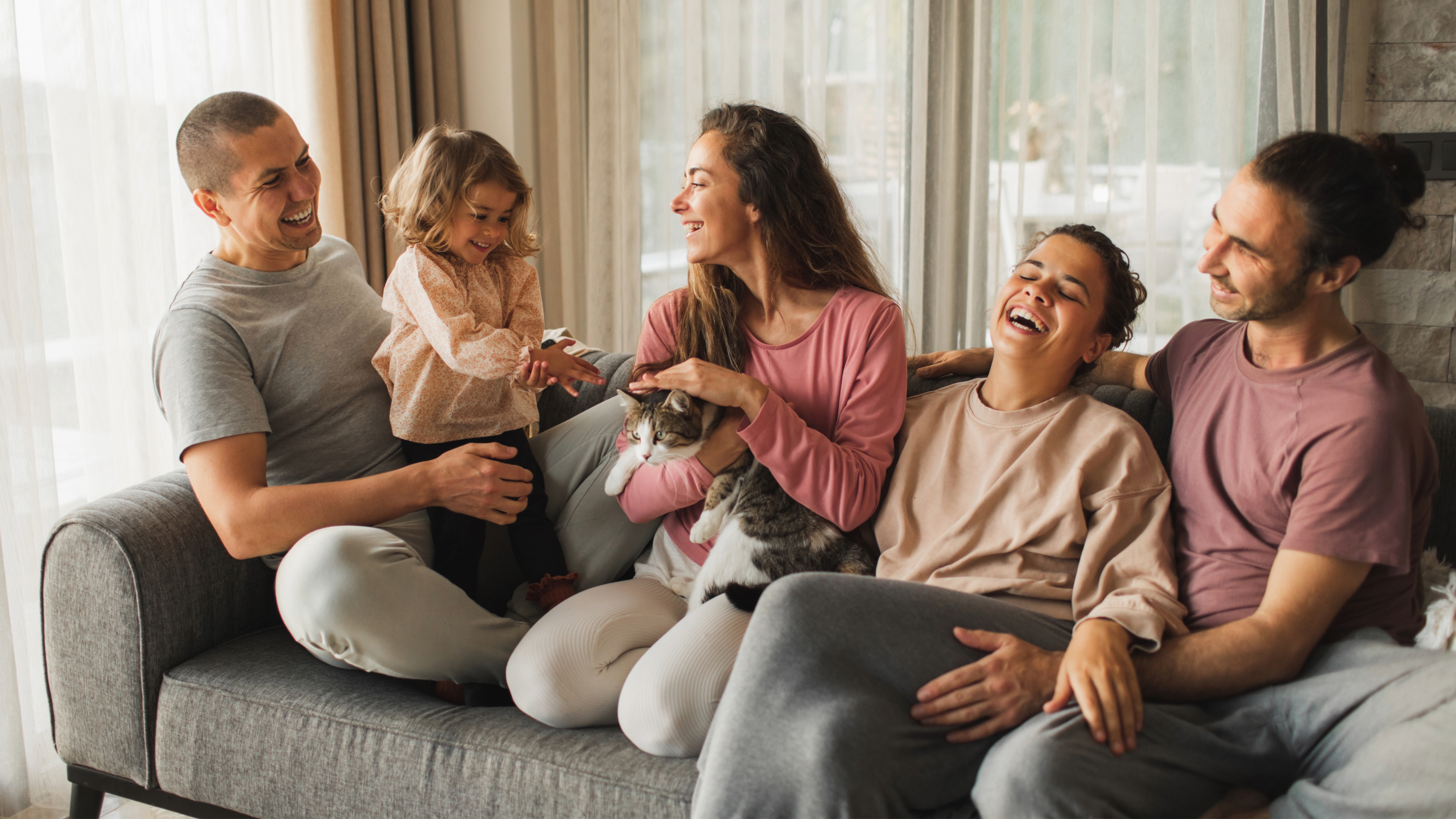People sitting on couch with cat