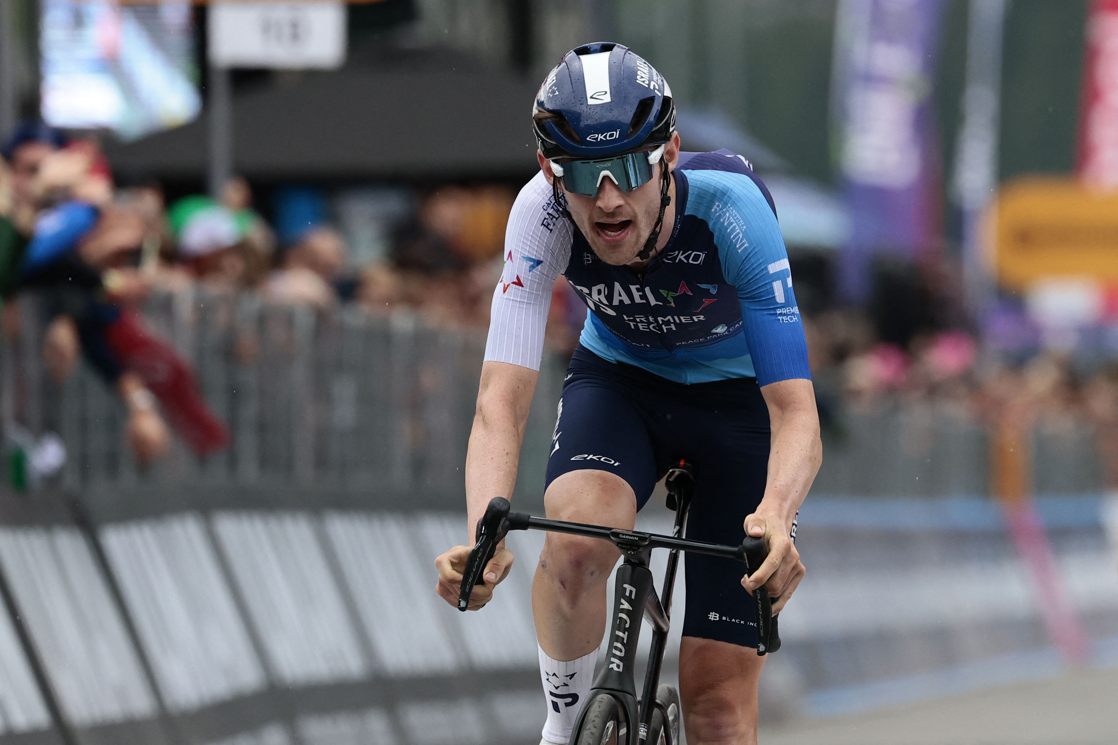 Israel-Premier Tech's Canadian rider Derek Gee crosses the finish line of the 17th stage of the 108th Giro d'Italia cycling race, 155kms from San Michele all'Adige to Bormio, on May 28, 2025. (Photo by Luca Bettini / AFP) (Photo by LUCA BETTINI/AFP via Getty Images)