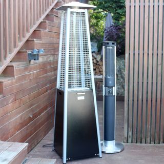 The Outsunny 11.2kw Pyramid Gas Patio Heater and Swan Column Electric Patio Heater side by side on wooden decking