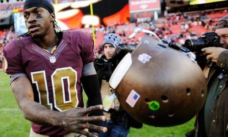 Washington Redskins quarterback Robert Griffin tosses his helmet after losing on Nov. 4