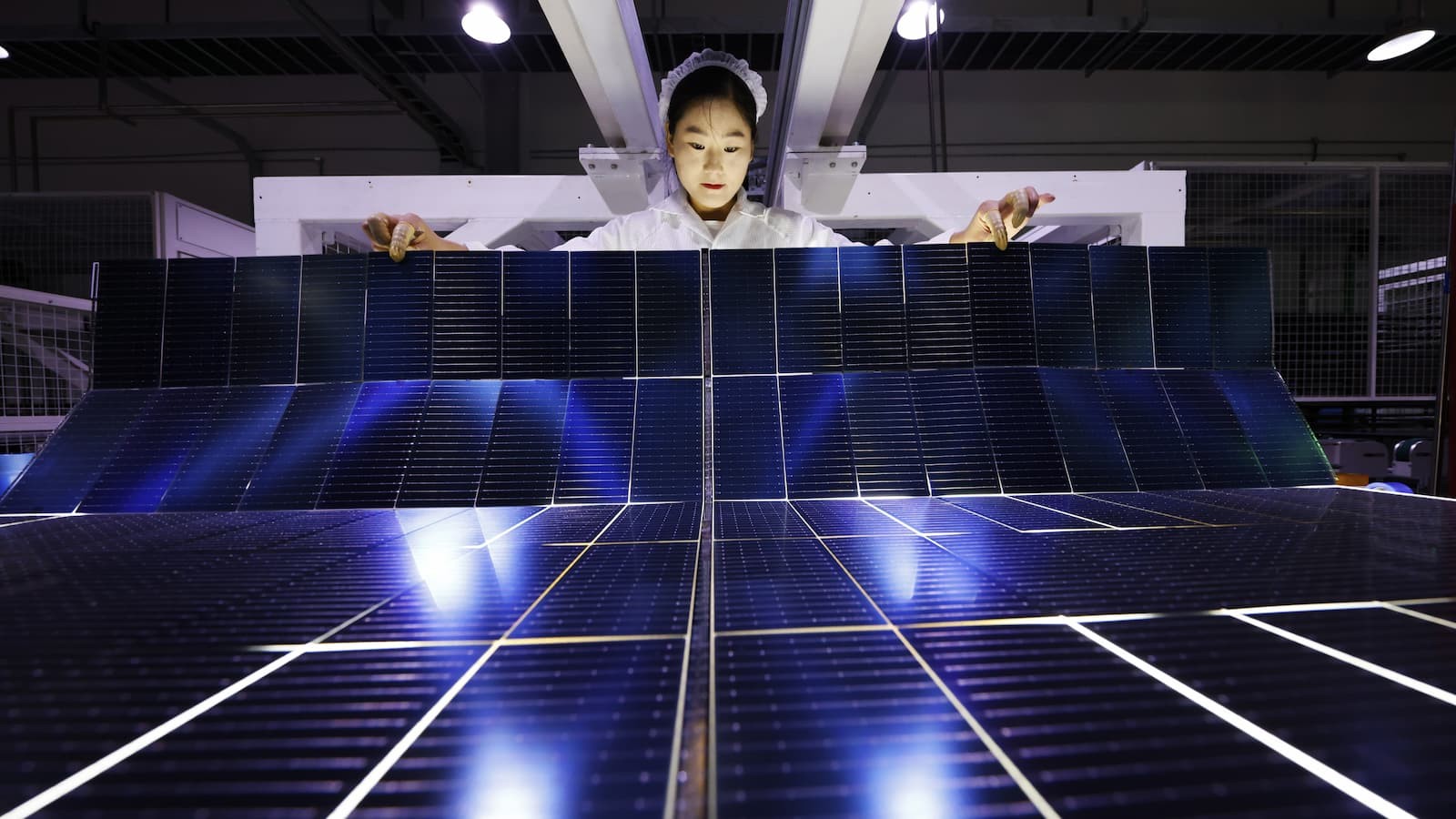 Someone making solar panels in a factory