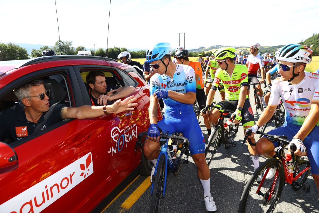 TRONDHEIM NORWAY AUGUST 14 LR Dylan Groenewegen of Netherlands and Team BikeExchange Jayco and Fabien Doubey of France and Team Total Energies talk with the race director after a group of protesters block the race during the 9th Arctic Race Of Norway 2022 Stage 4 a 1591km stage from Trondheim to Trondheim ArcticRace on August 14 2022 in Trondheim Norway Photo by Michael SteeleGetty Images