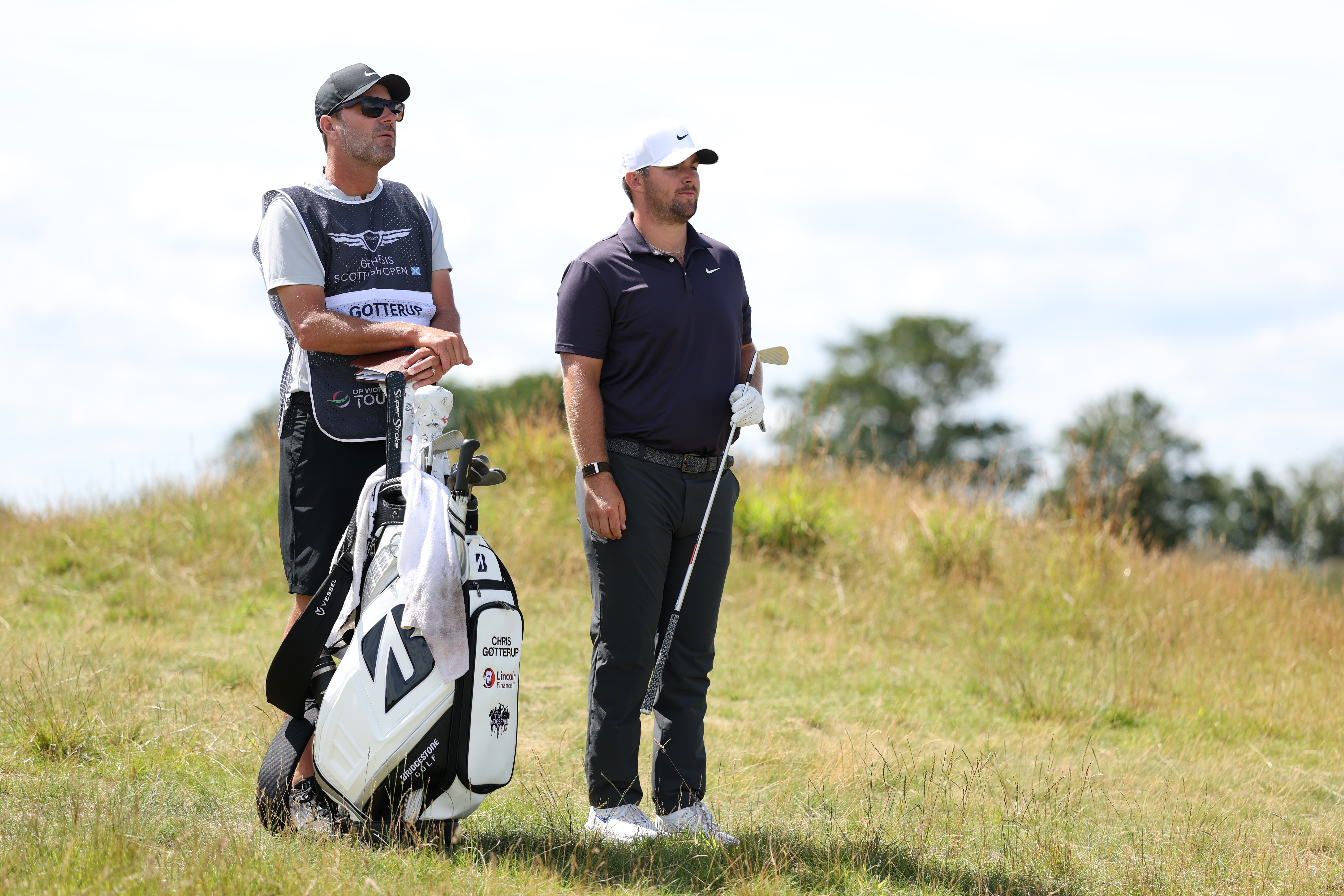 Chris Gotterup speaks to his caddie