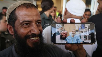 Relative of freed Israeli hostage Qaid Farhan Alkadi shows photo from hospital