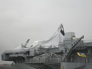 Space shuttle Enterprise is seen after Hurricane Sandy at the Intrepid Sea, Air and Space Museum in New York on Oct. 30, 2012. Photos show the shuttle's protective shelter has collapsed and the orbiter has incurred some damage.