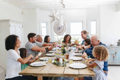 family around the table at Christmas during lockdown rules