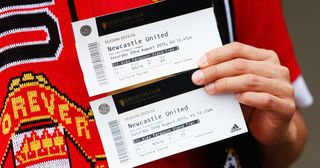 Best football tickets : A Manchester United fan holds two match tickets prior to the Barclays Premier League match between Manchester United and Newcastle United at Old Trafford on August 22, 2015 in Manchester, England.