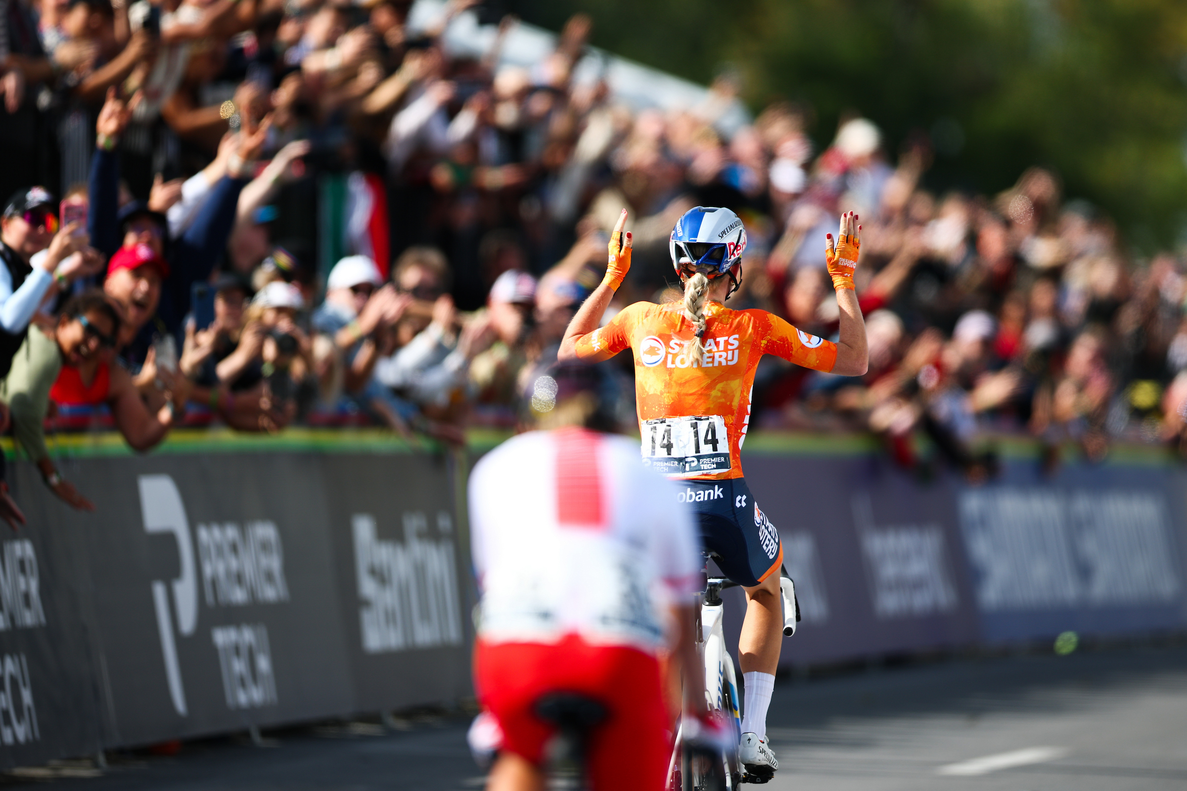 Shot from behind, Demi Vollering crosses the line in fornt of Kasia Niewiadoma to win the women's road race at the 2026 World Championships