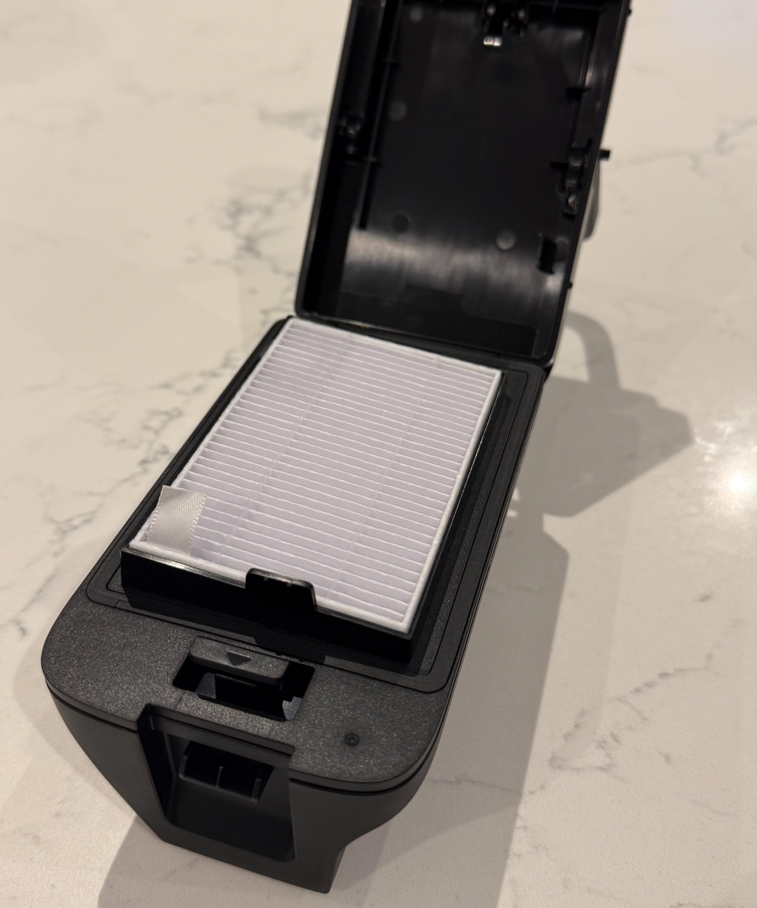 Close-up of eufy Omni C28 HEPA-style filter inside dust bin