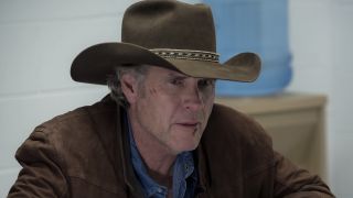 Robert Taylor in Longmire wearing brown coat, blue collared shirt and brown cowboy hat