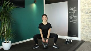 Personal trainer Alanah Bray demonstrates a sumo squat