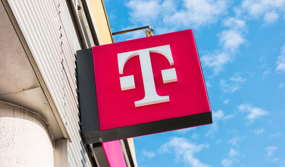 A pink T-Mobile logo on a storefront in Aachen, Germany