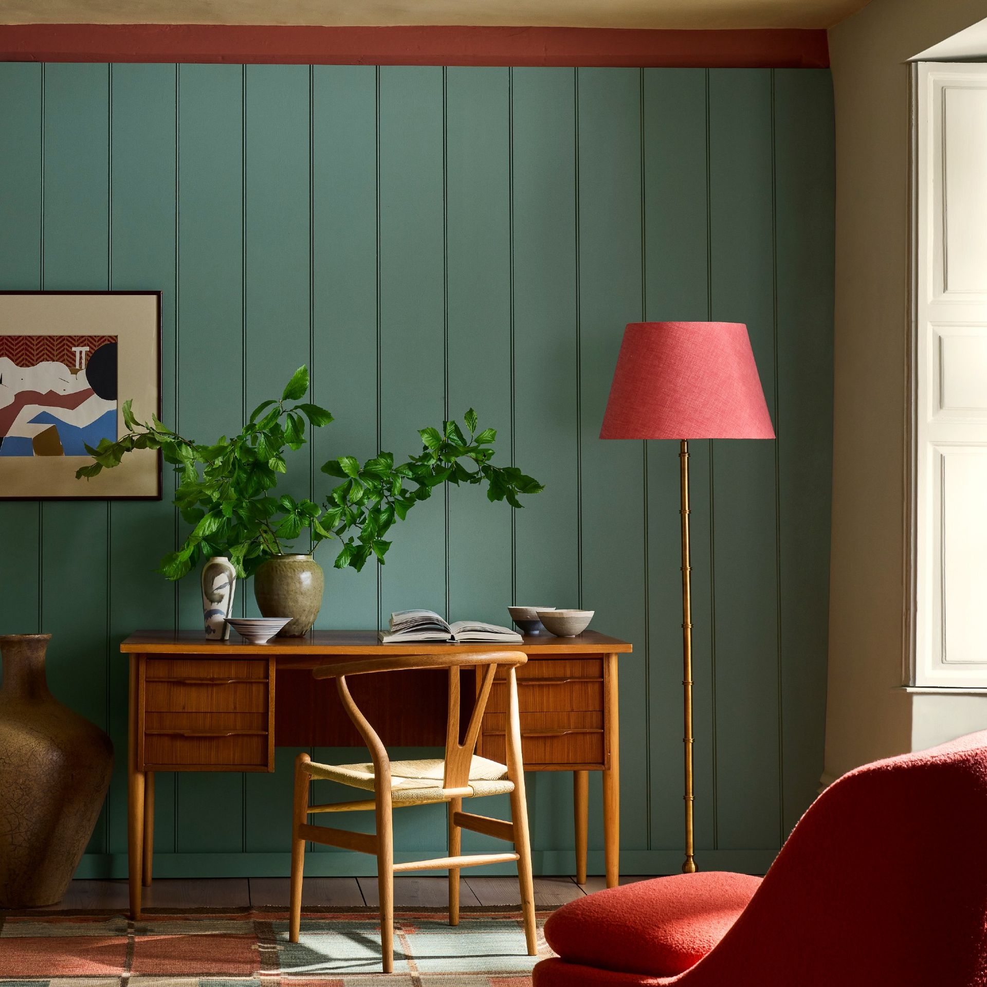 A home office with panelled walls painted in Little Greene's new Perpetual Blue shade