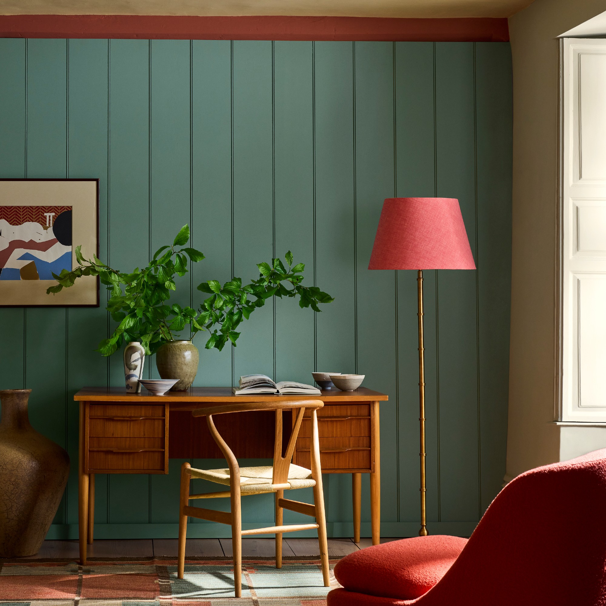 A home office with panelled walls painted in Little Greene's new Perpetual Blue shade