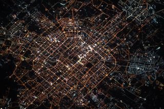 China's capital city of Beijing glitters at night in this photo by NASA astronaut Jessica Meir taken on Jan. 24, 2020, the night before the start of the lunar new year, as seen from the International Space Station.