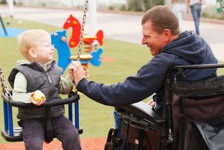 disabled father and son at playground