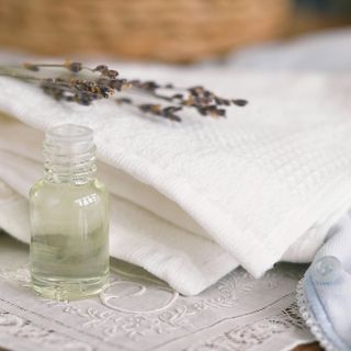 fly repellent in glass bottle and white cloth