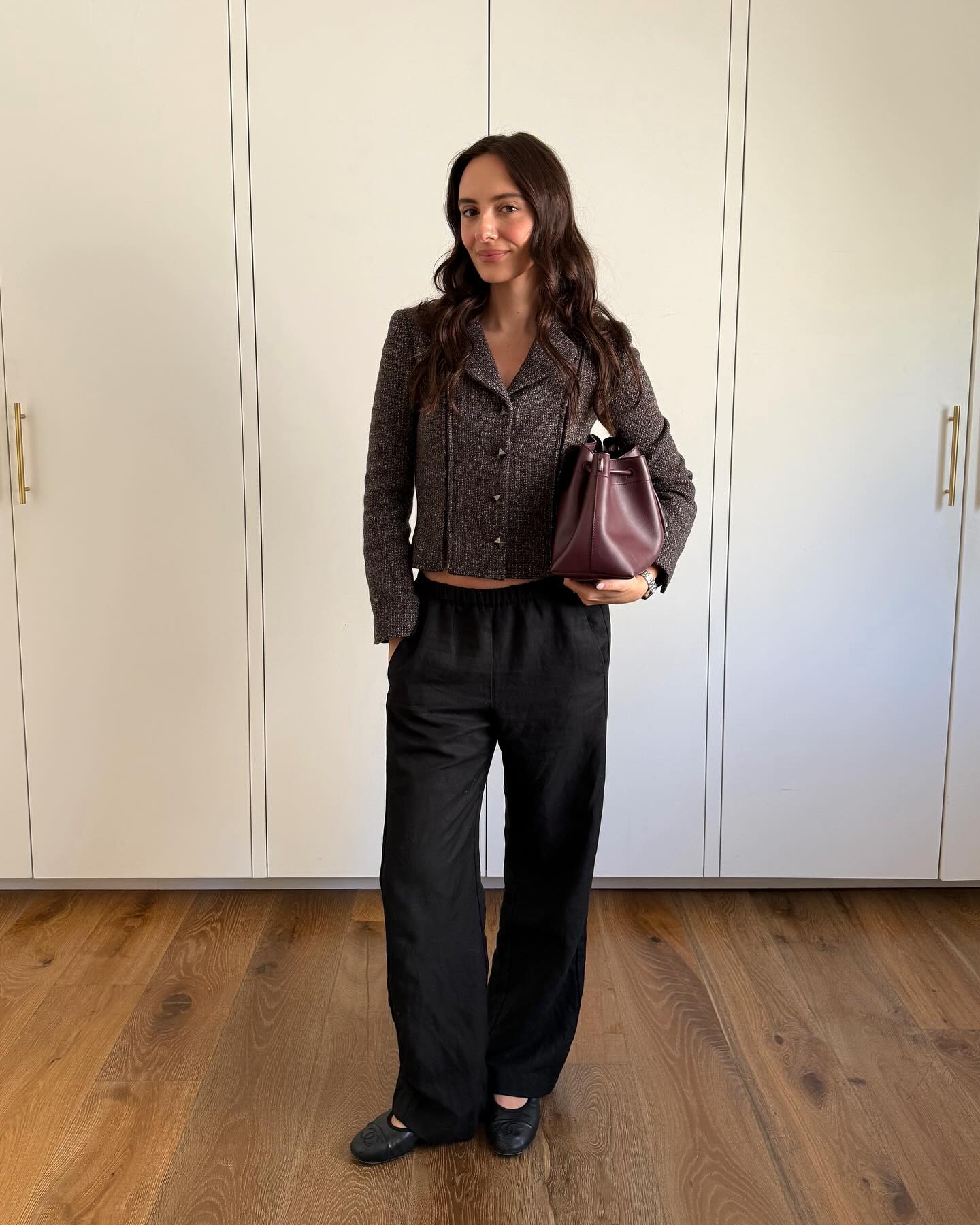 Influencer Liv Perez wearing a tweed jacket and black pants